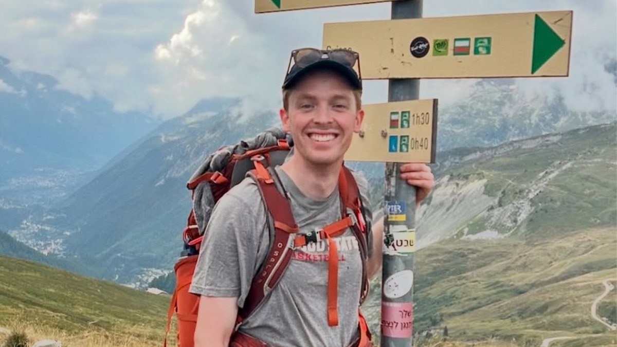 Guilford Cole Henderson is seen hiking on mountains