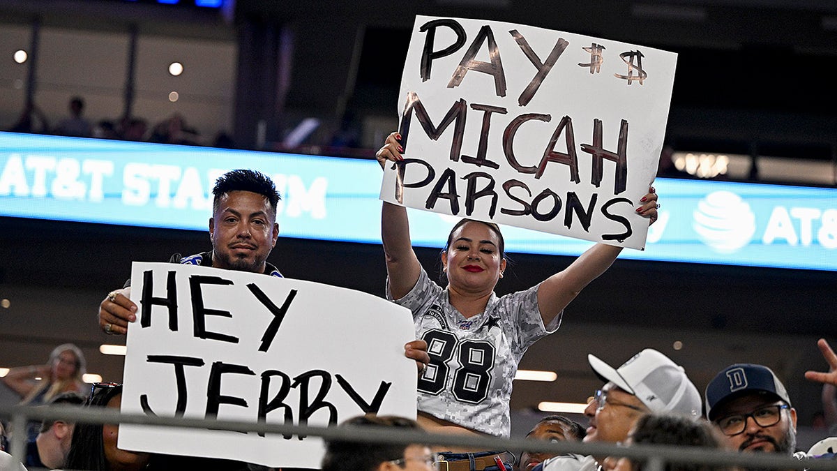 Cowboys fans display signs