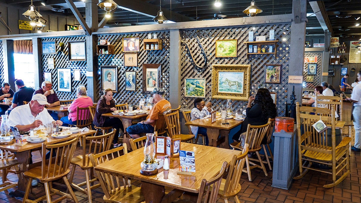 Cracker Barrel Old Country Store customers eat at separate tables nearby.