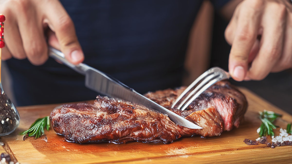 cutting into steak