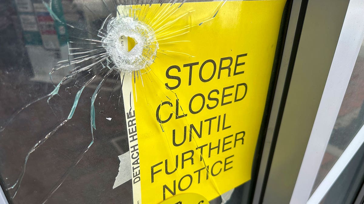 bullet hole in glass door of CVS