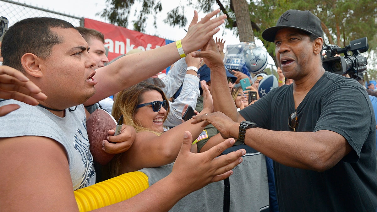 Denzel Washington interacts with Dallas Cowboys fans