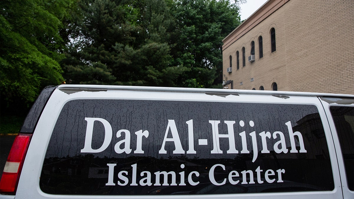 A vehicle is parked outside the mosque with a Dar Al Hijrah Islamic Center sign on it in Falls Church, Virginia, U.S.