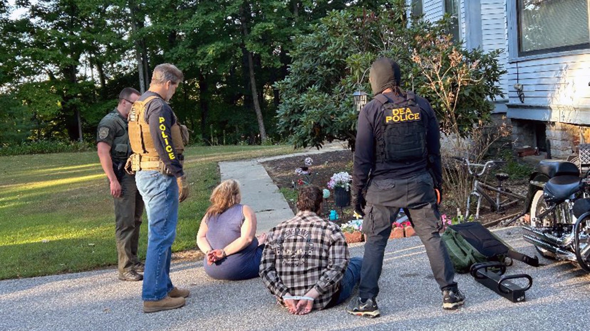 DEA officers detain suspects outside Franklin, New Hampshire home in fentanyl trafficking case.