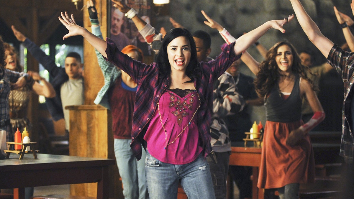 Demi Lovato dancing alongside Alyson Stoner in a scene from Disney's hit "Camp Rock."