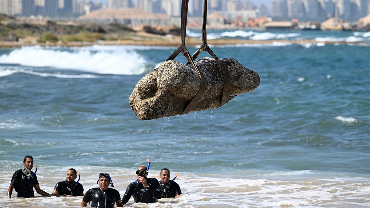 Crane draws an artifact of the waters of Abu Qir Bay in Alexandria