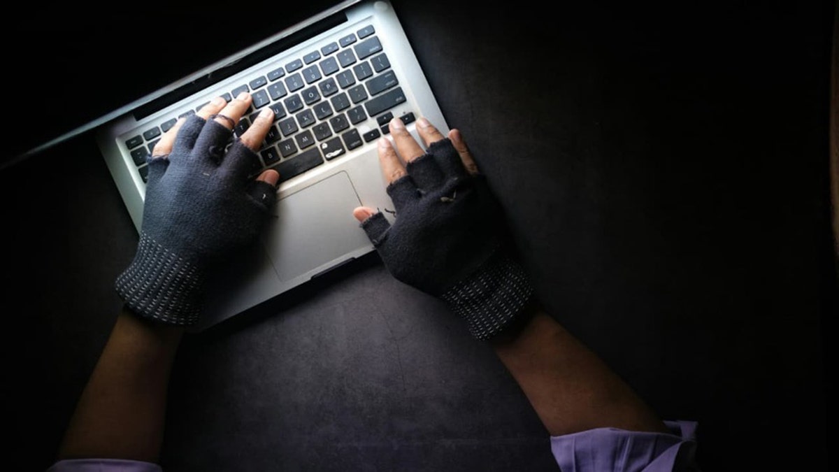 The infiltrator uses a laptop to steal data.