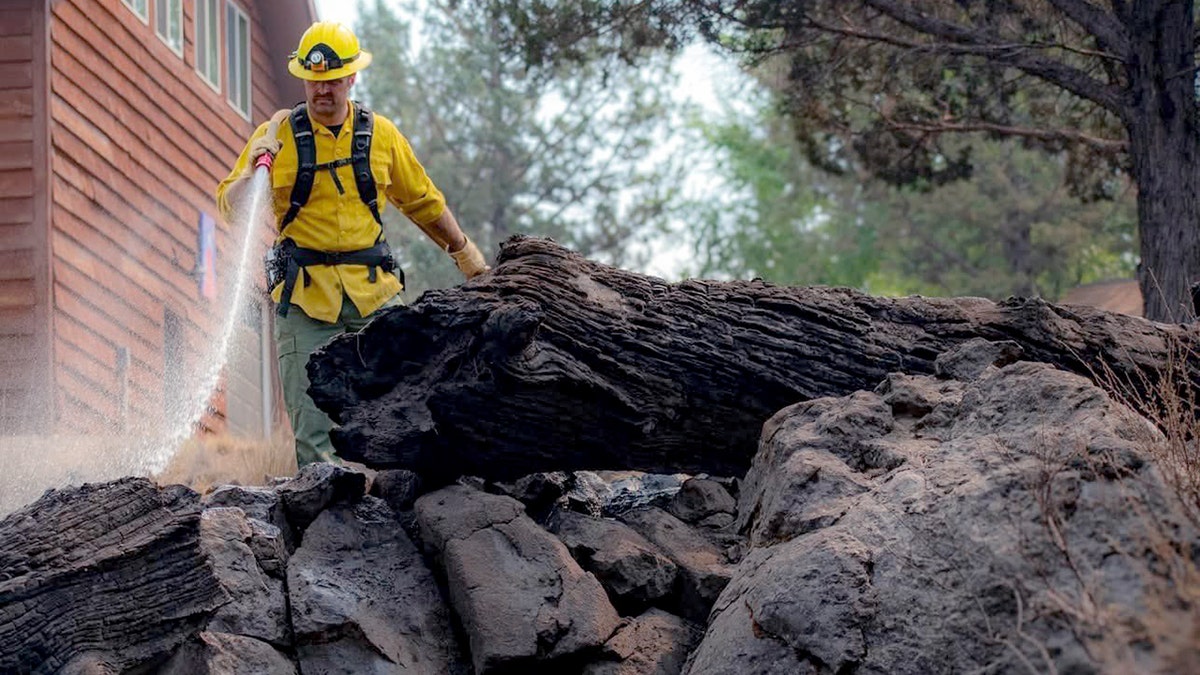 Firefighter spraying water