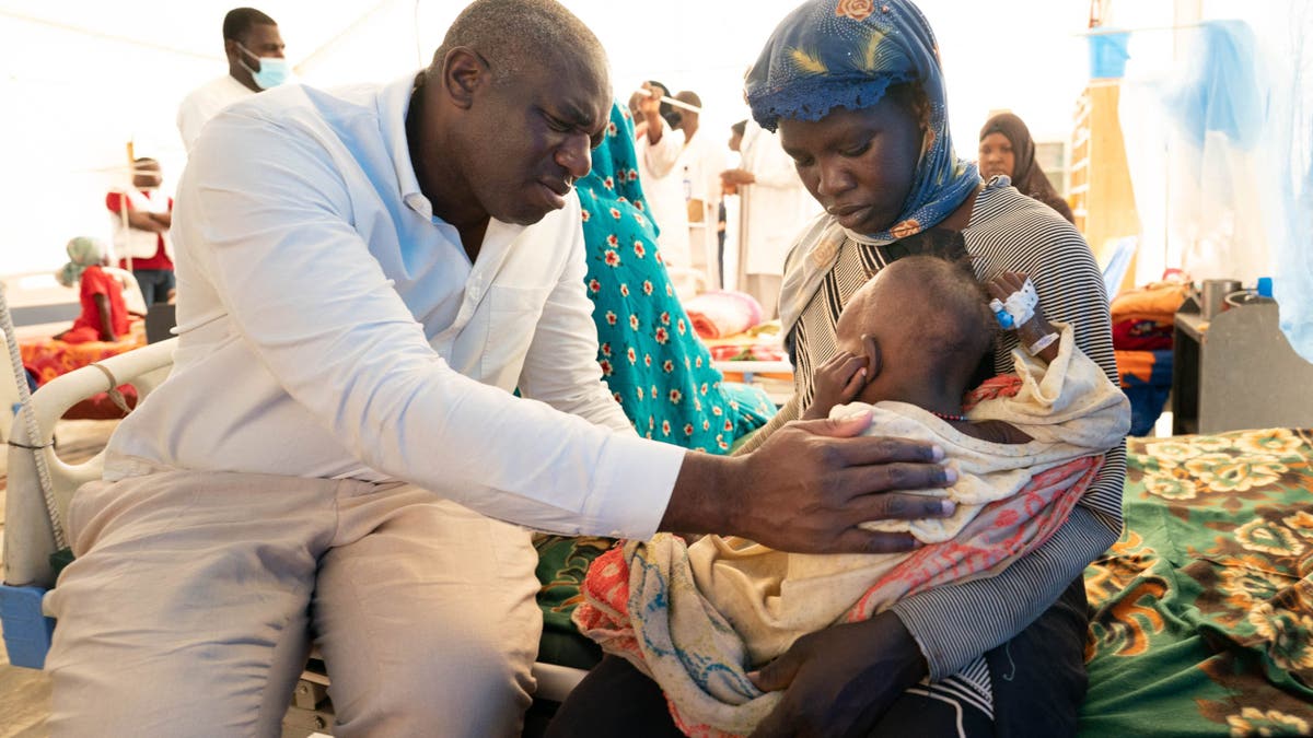 couple with child at malnutrition center near Chad border