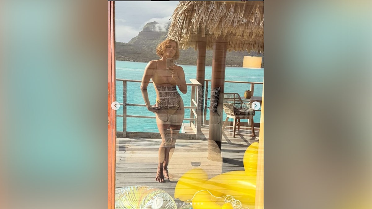 Berry took a selfie of her reflection while in the gold bikini.