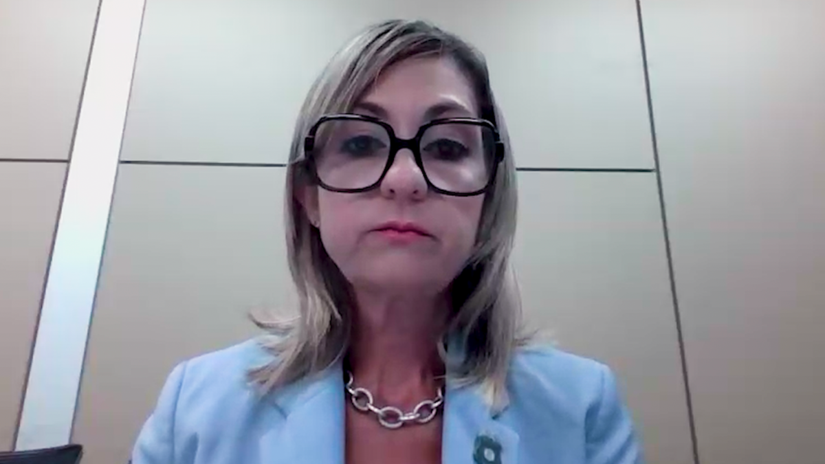 woman with glasses, blond hair in light blue blazer on zoom interview