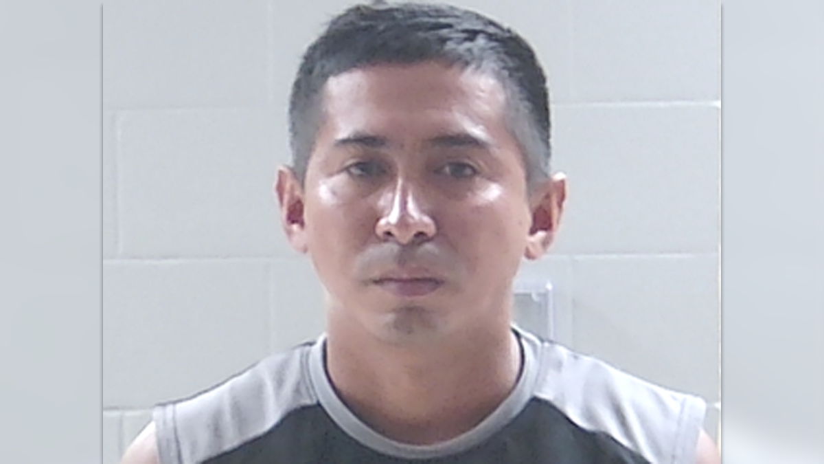 Juan Alfredo Chavarria-Lezama wearing a sleeveless gray and black shirt in his Livingston Parish mugshot