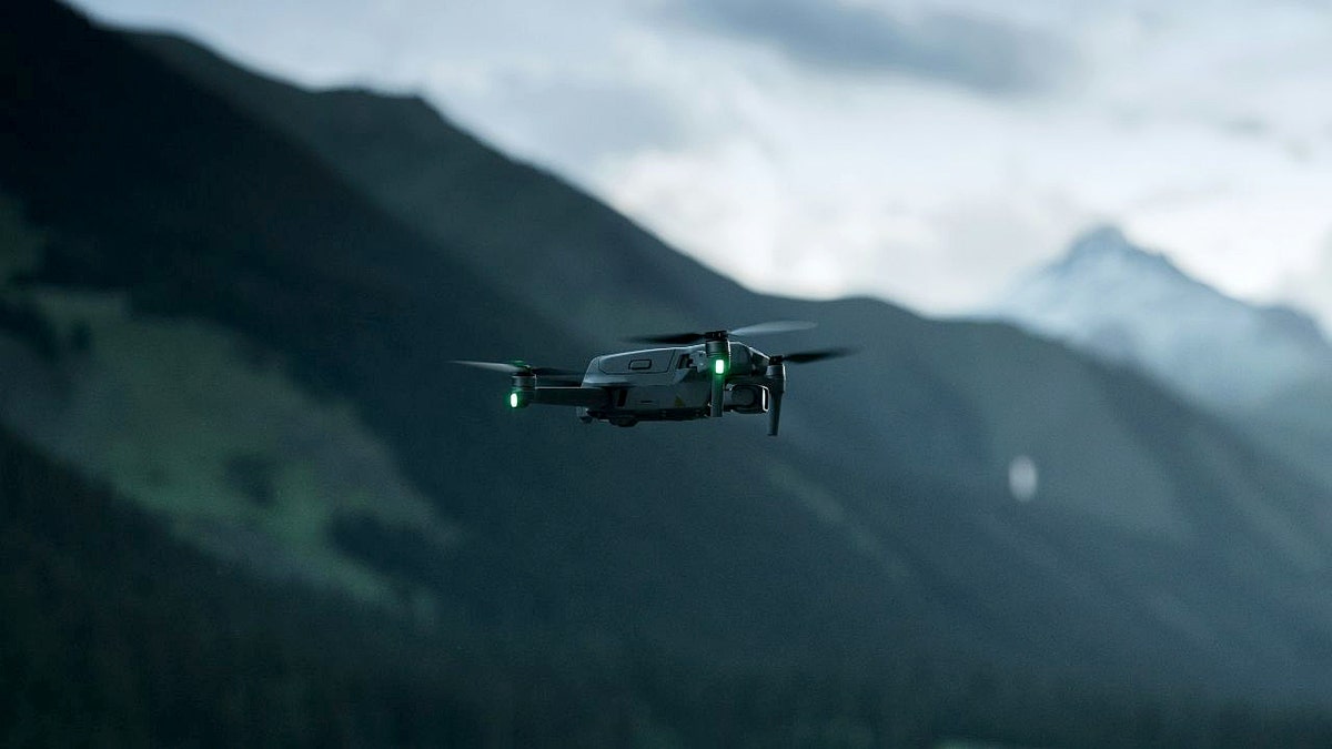 A drone with mountains behind it