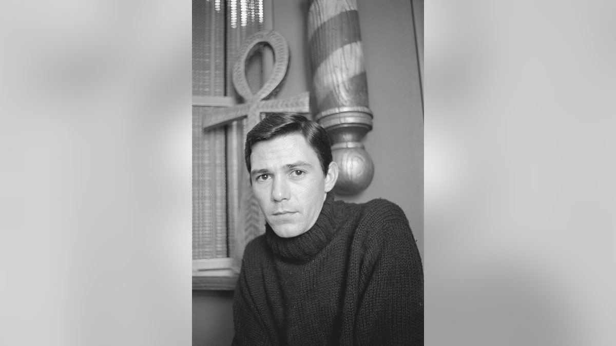 Jay Sebring wearing a black turtleneck sweater.