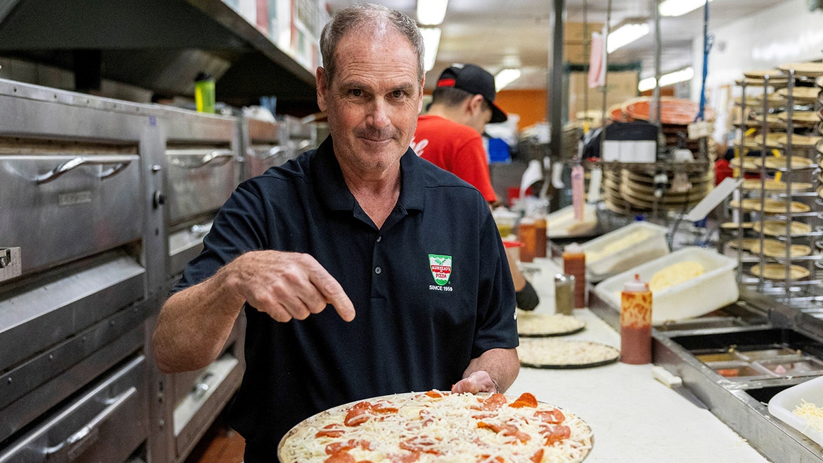 joe-aurelio-holds-pizza Trust-Fuel Pizza Mission Pope Leo Fourths delivers the Holy Slice of the house