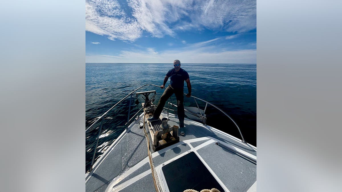 Joe Mazraani standing on a boat out on the open sea