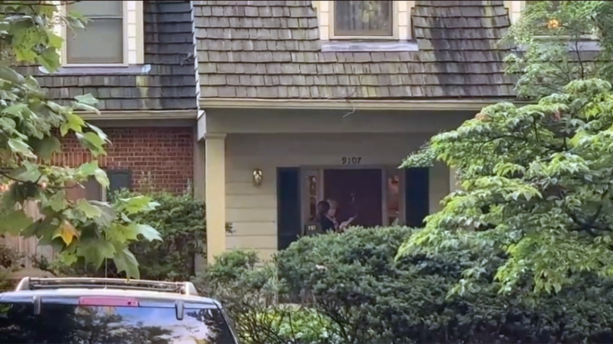 FBI agents in the doorway of John Bolton's house
