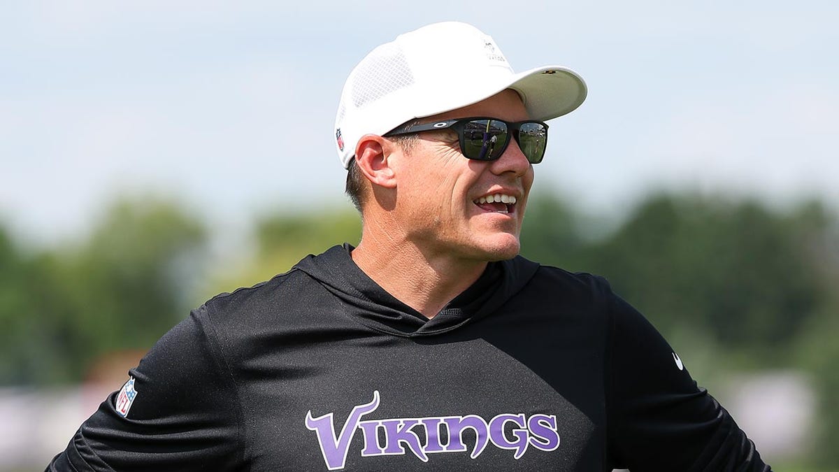 Kevin O'Connell smiles on practice field