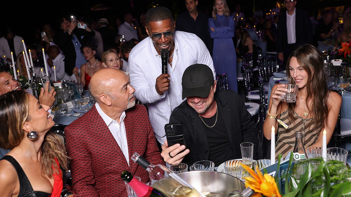 Leonardo DiCaprio at party with girlfriend and Jamie Foxx