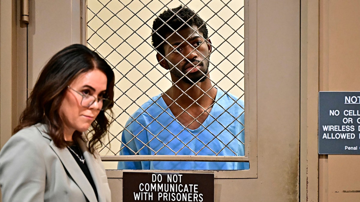 Lil Nas X wears blue jumpsuit at court hearing.