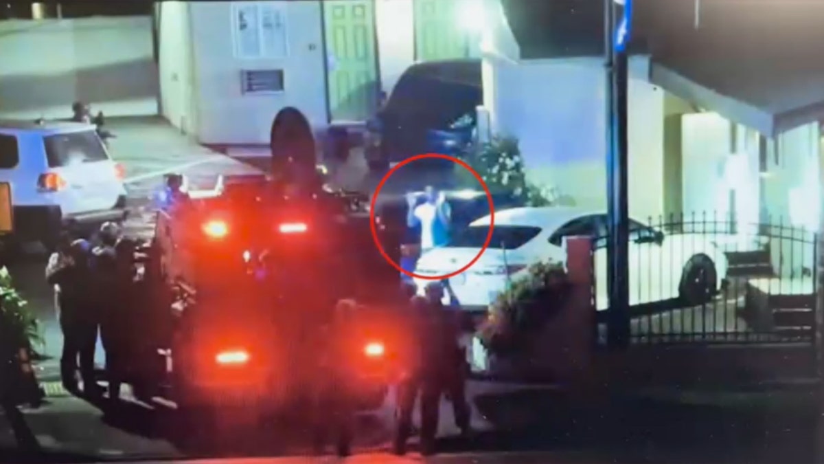 Feds raiding a gang as one man steps out with hands up 