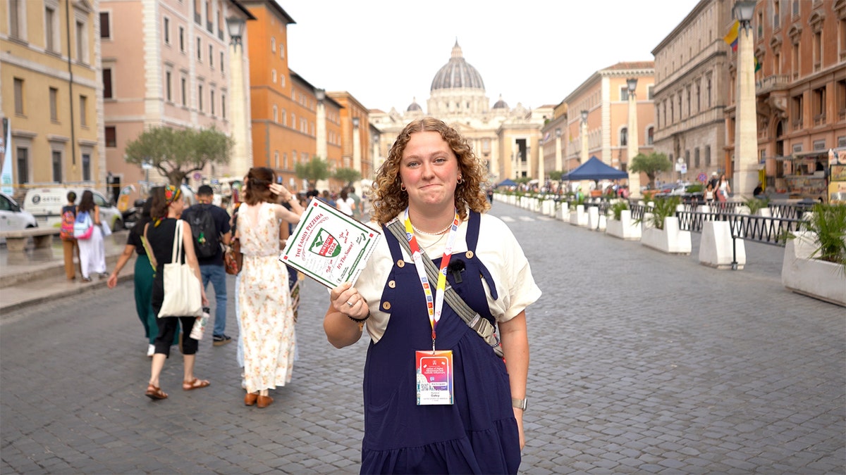 madeline-daley-holding-aurelios-pizza-box-to-give-to-pope Trust-Fuel Pizza Mission Pope Leo Fourths delivers the Holy Slice of the house