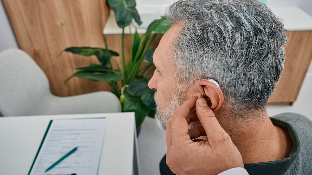 A man is equipped with hearing aid
