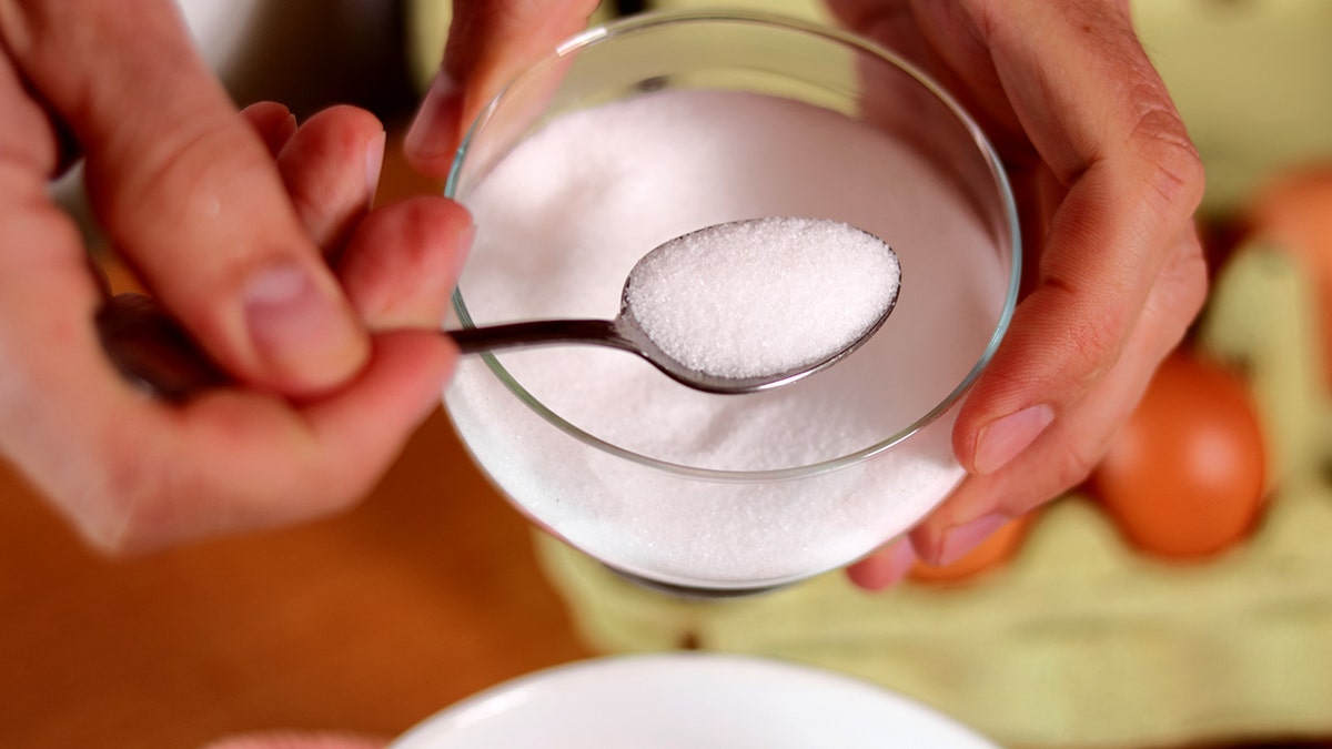 Man spooning salt