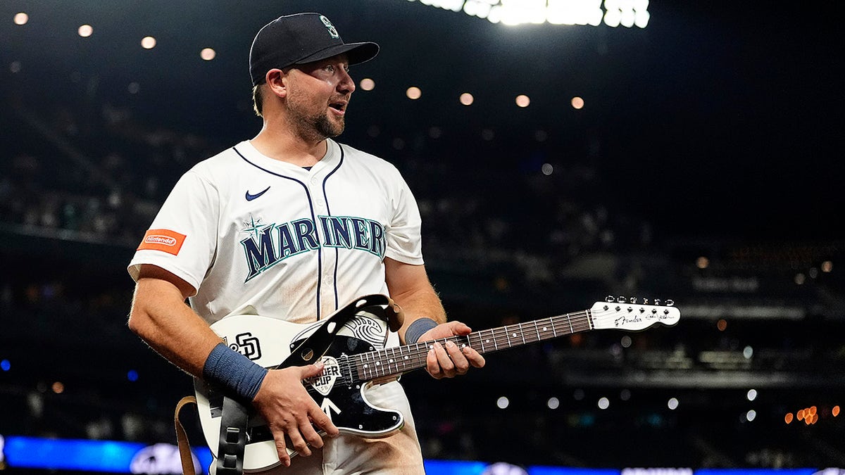 Cal Raleigh with a guitar
