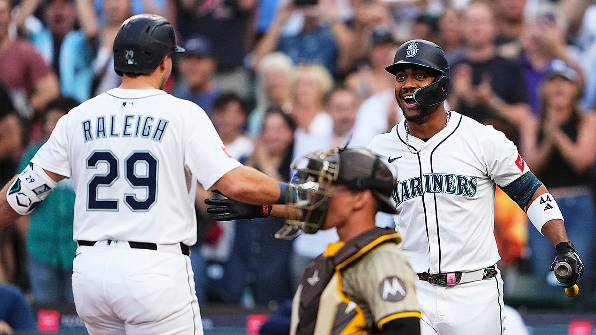 Cal Raleigh and Julio Rodriguez celebrate