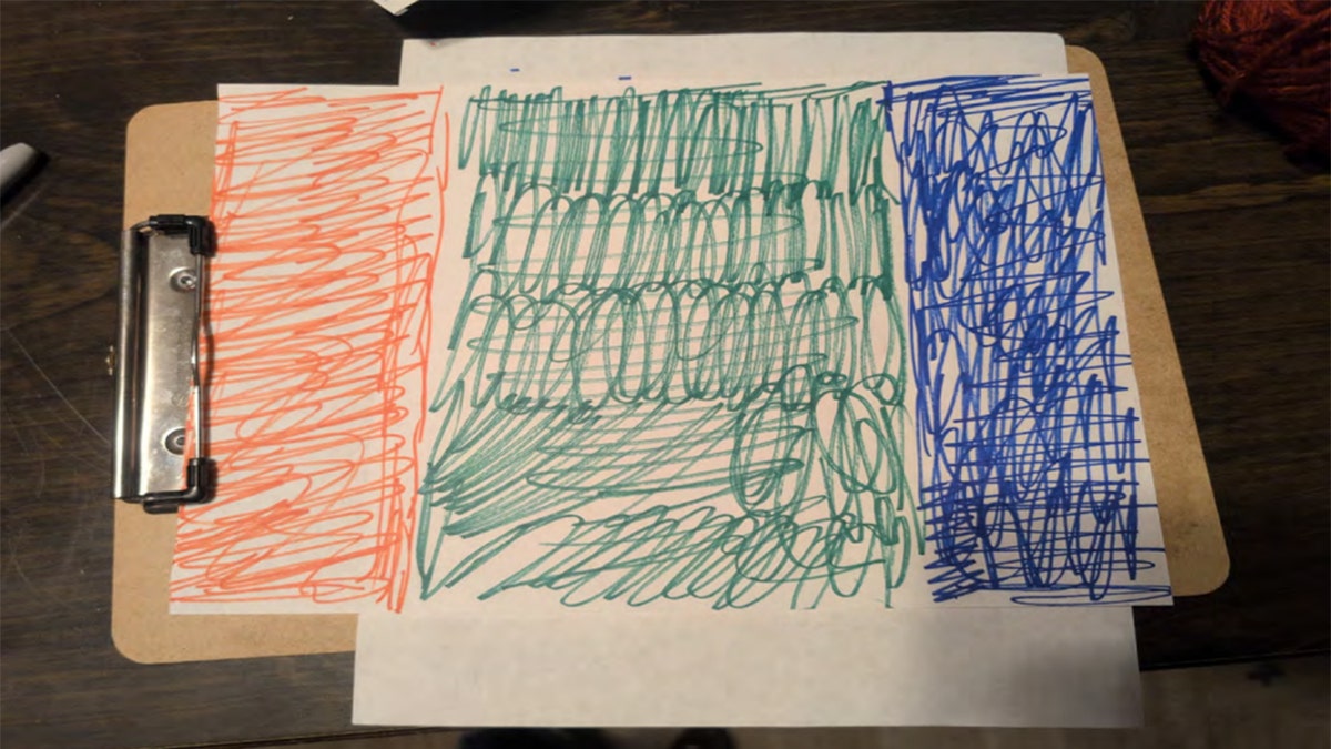 Hand-drawn red, green, and blue flag design on paper
