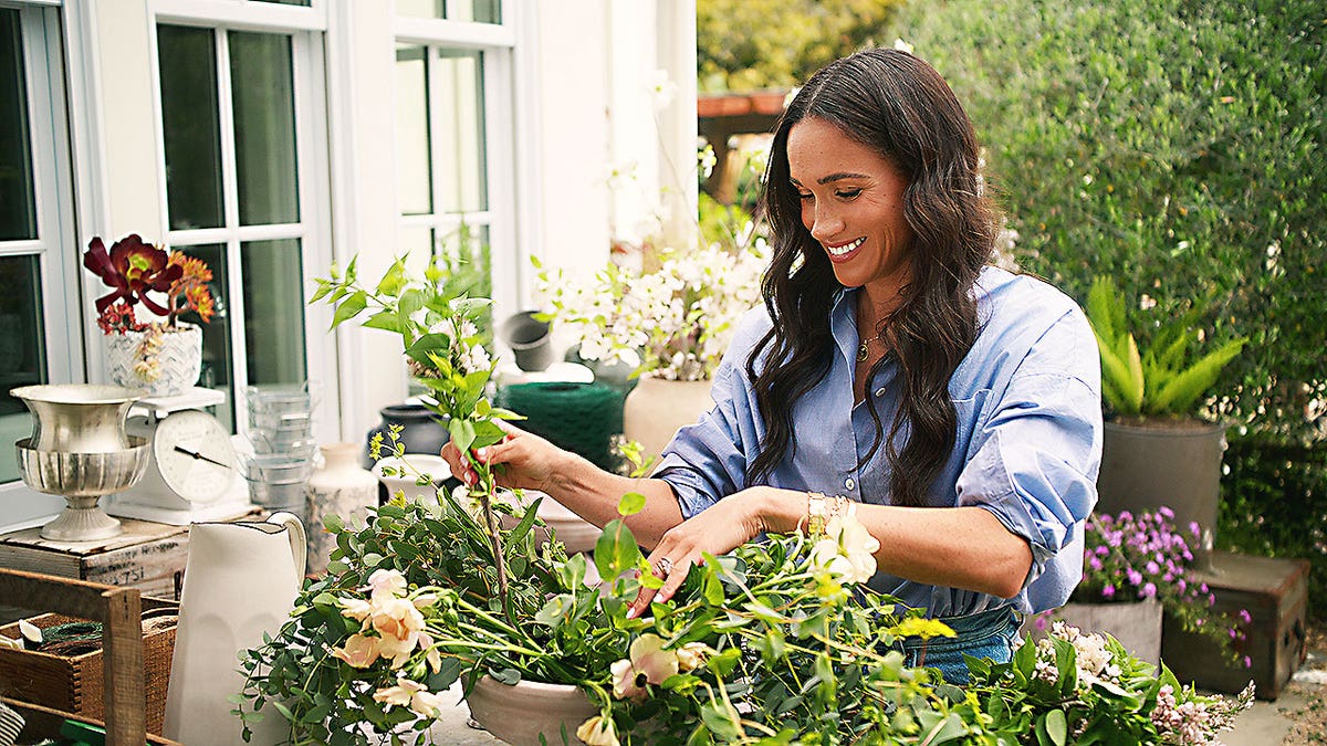 Meghan Markle smiling while gardening in an episode of Netflix's "With Love, Meghan."
