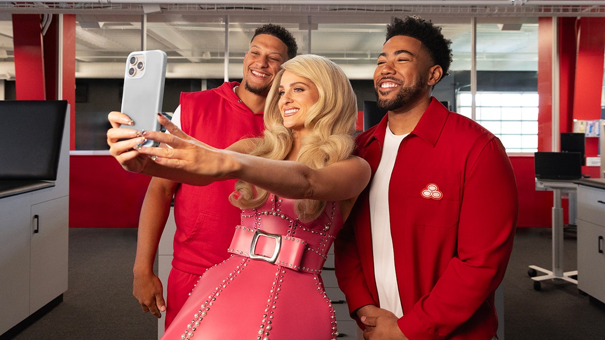 Meghan Trainor poses for a selfie with Patrick Mahomes and Jake from State Farm.
