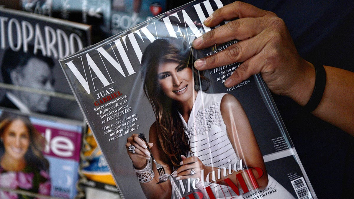 Man hold Vanity Fair featuring Melania Trump.