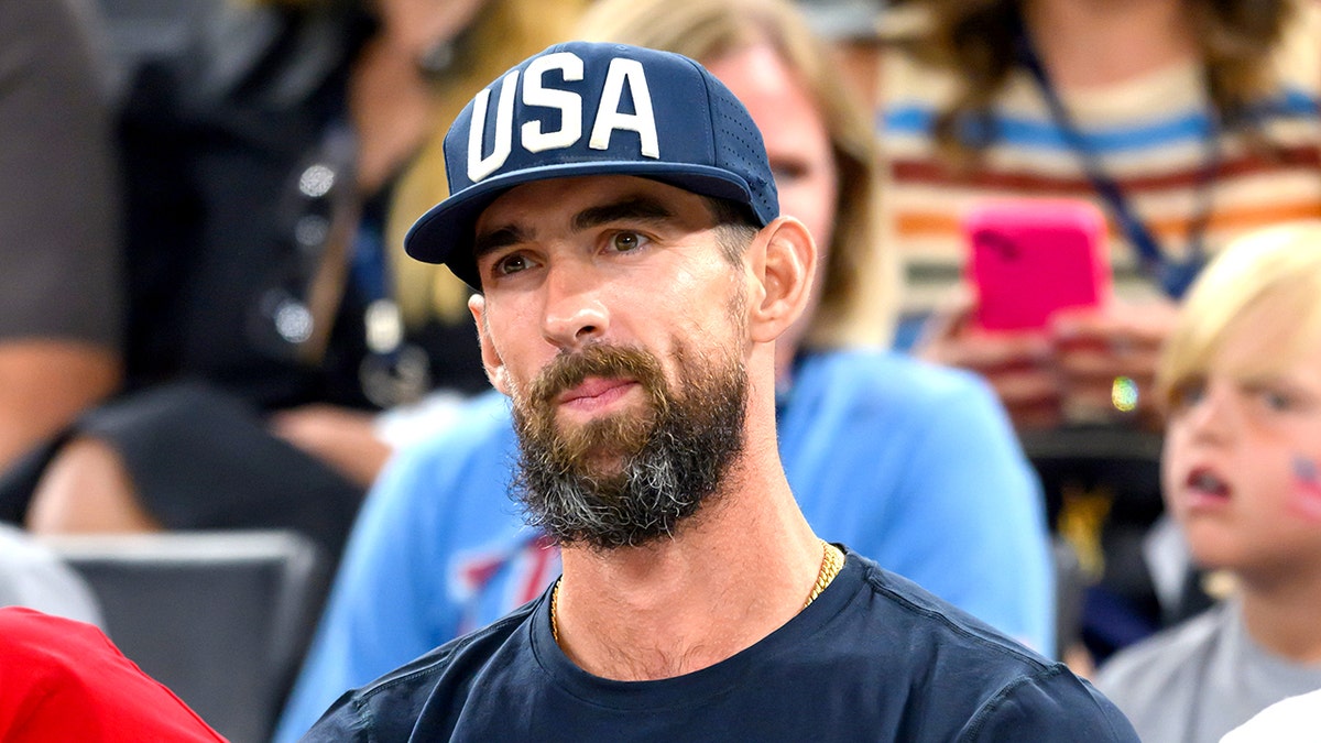 Michael Phelps looks on basketball court