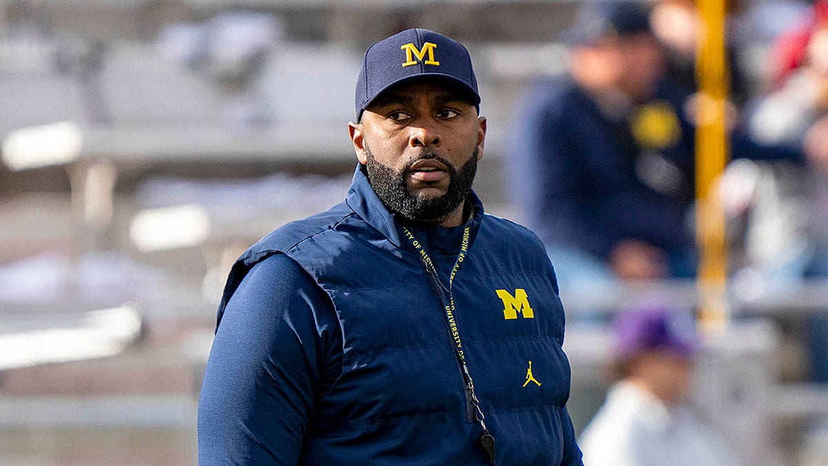 Sherrone Moore looks on