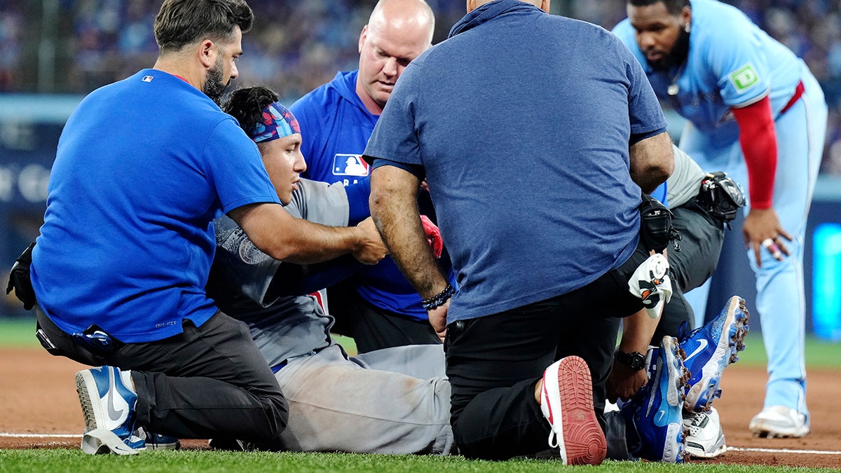 Miguel Amaya is tended to by medical staff