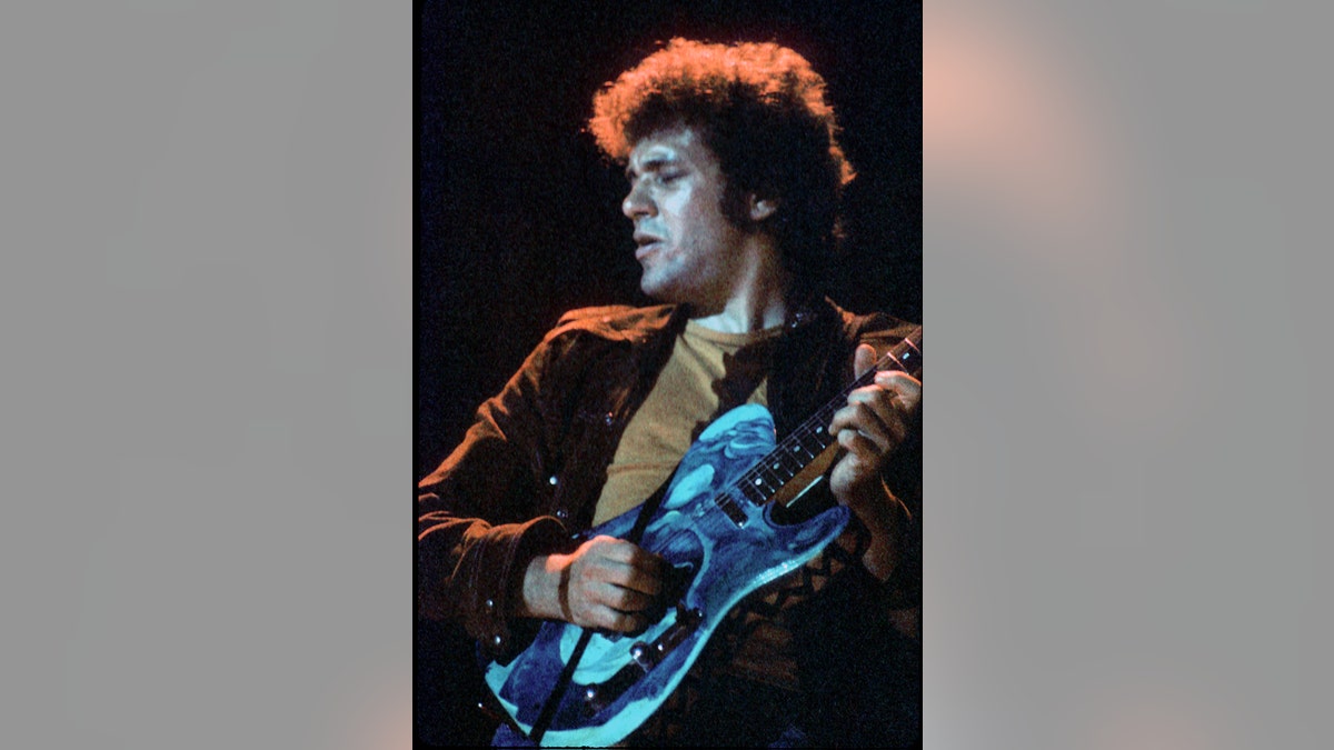 Mike Bloomfield playing guitar on stage.