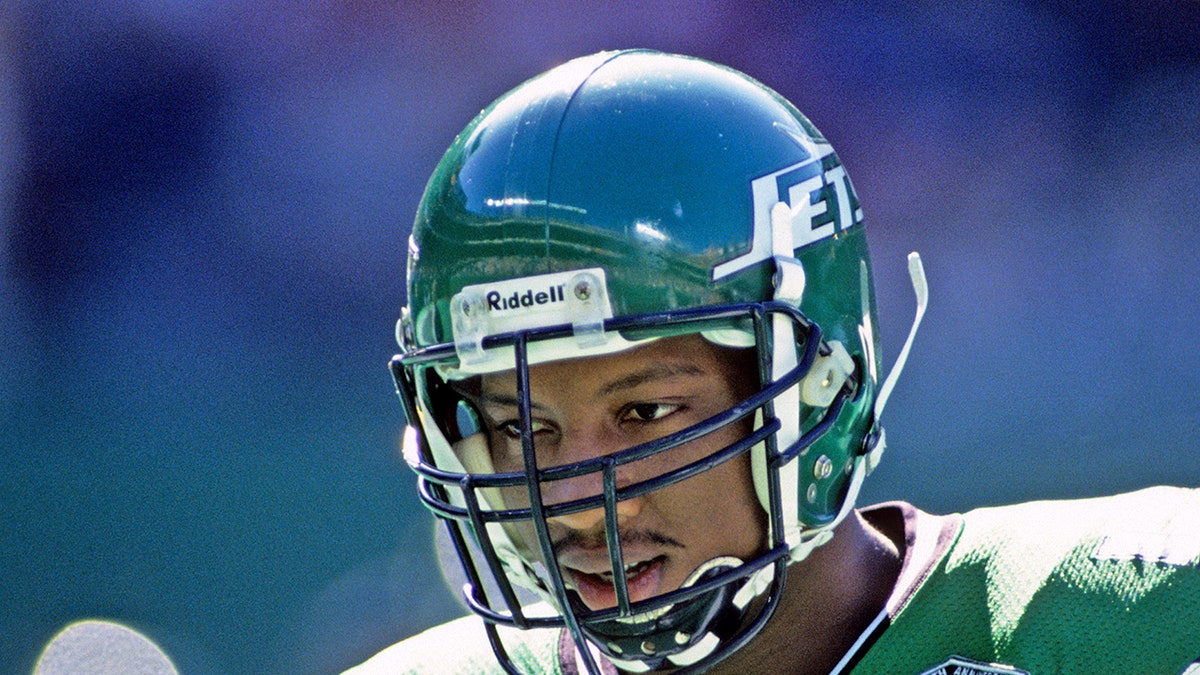 Mo Lewis looks on during a New York Jets game