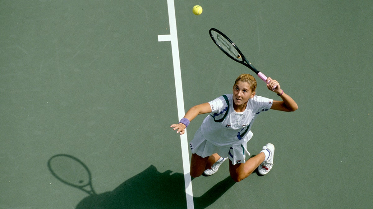 Monica Seles tosses serve