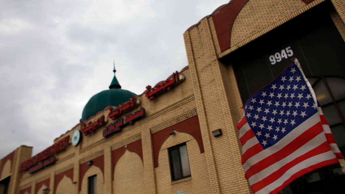 An American flag hangs on a car outside the American Muslim Society mosque in Detroit,