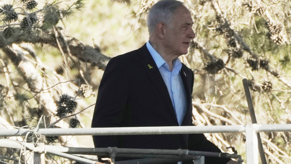 Israeli Prime Minister Benjamin Netanyahu is held on a platform overlooking the Gaza Strip during his first visit to Kibbutz Nir Oz since the attack on October 7, 2023 by Hamas terrorists where a large number of this community was killed or captured, near the Israel-Gaza border in southern Israel, on Thursday, July 3, 2025.