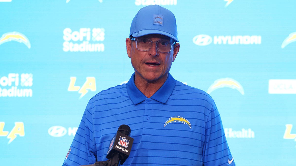 Jim Harbaugh talks to reporters