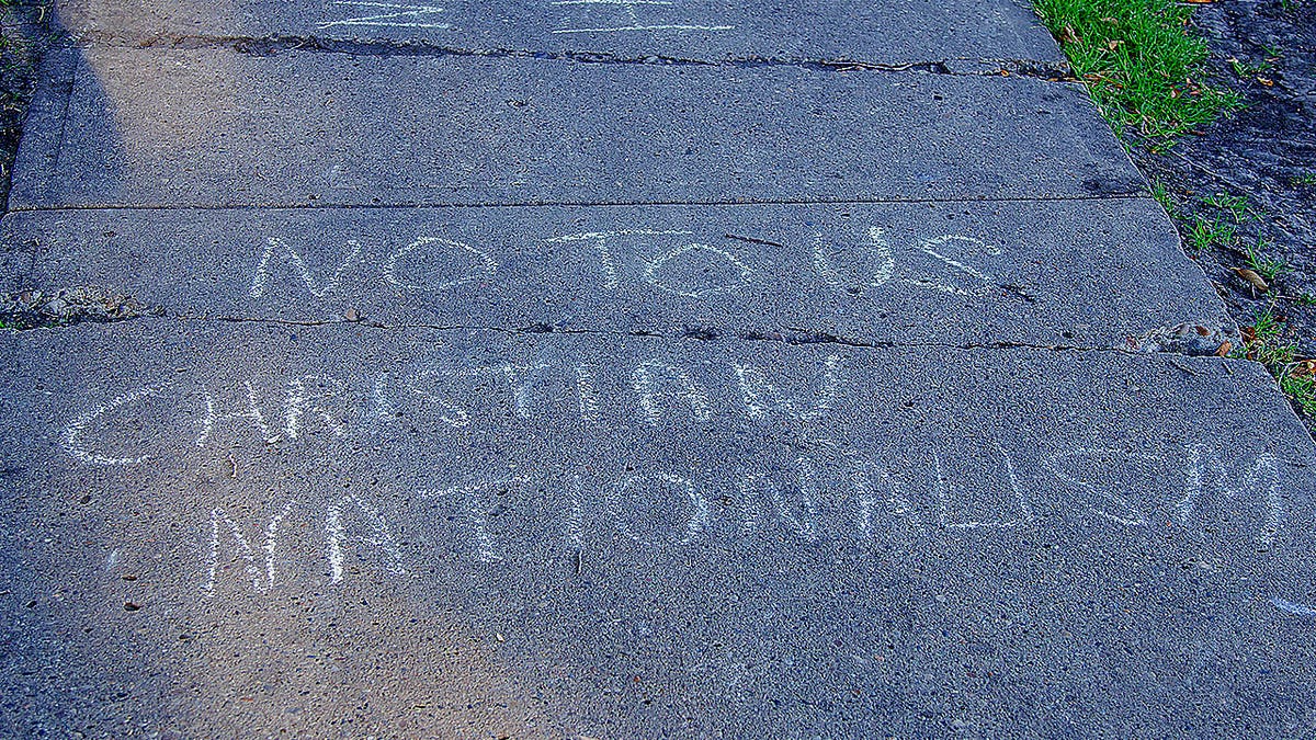 Protest chalk against Christian nationalism in Canada
