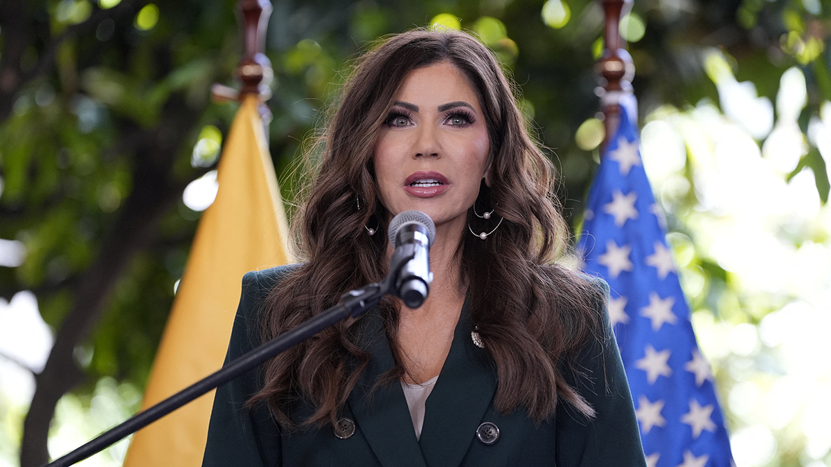 kristi-noem-speaking-flags