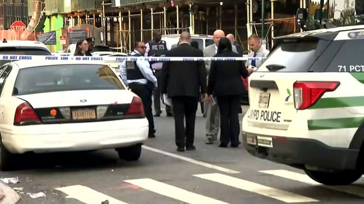 investigators convening in the street outside shooting scene