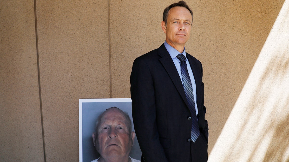 Paul was wearing a suit and stood beside the sphere of the Golden State Killer.