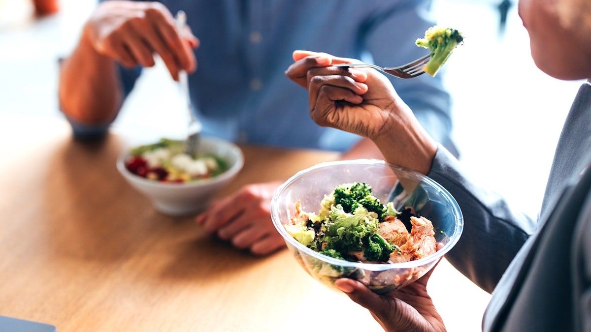People eating healthy vegetables at table
