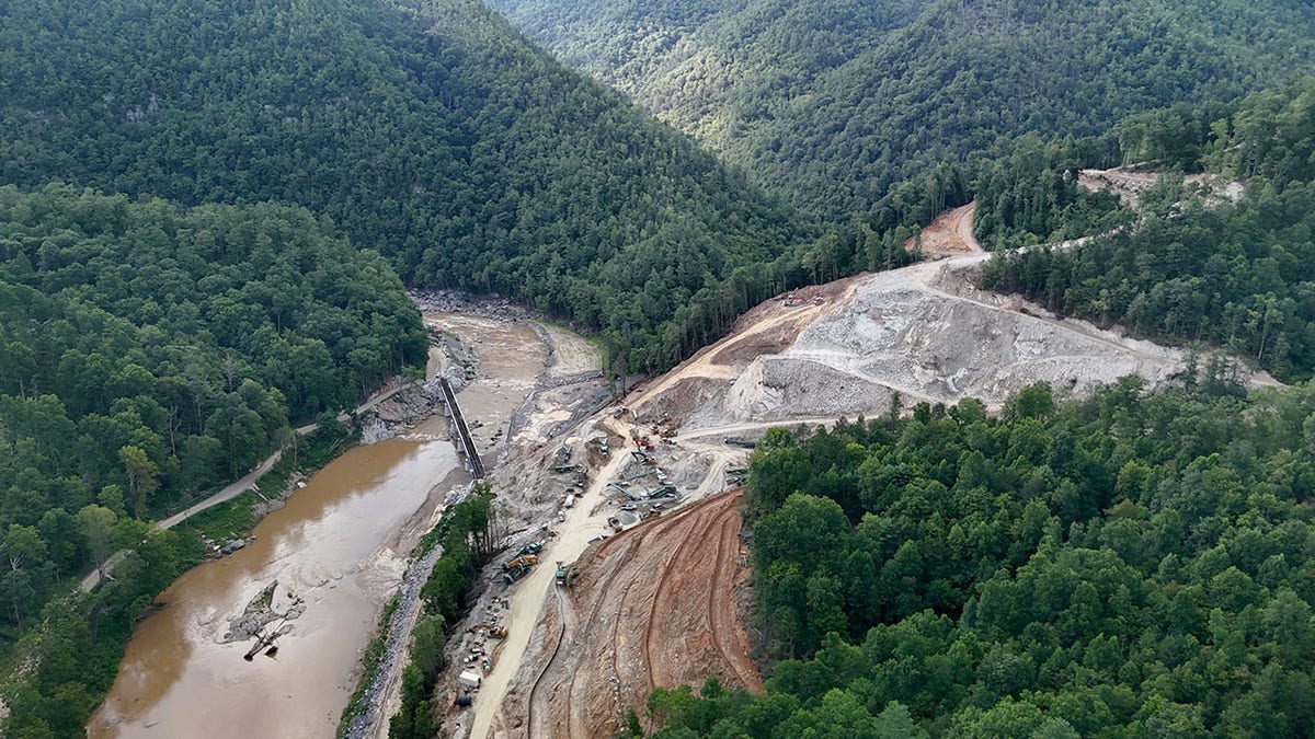 Dirt roads and a muddy river are seen in a forest at the site of a North Carolina mining operation.