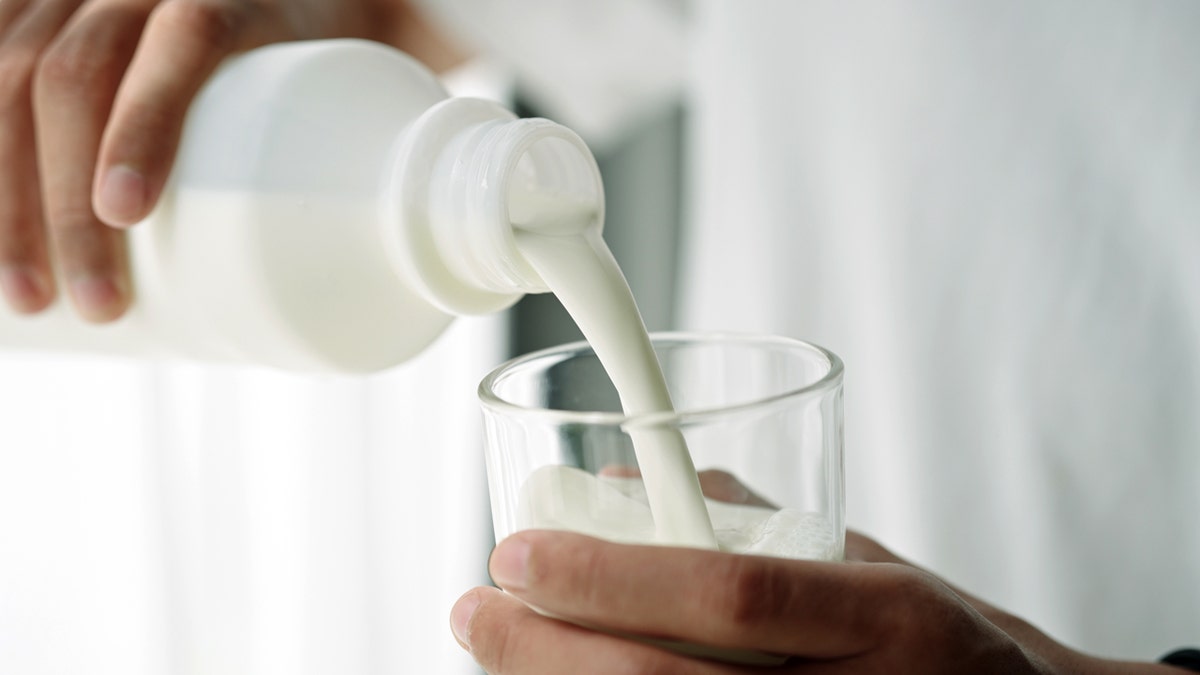 Milk is being poured into a glass.